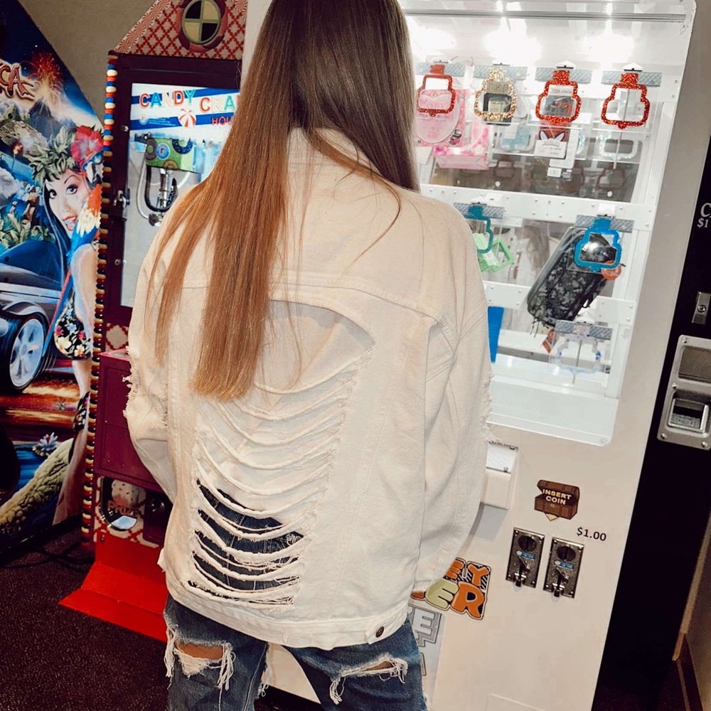 This oversized distressed Jean Jacket will complete any outfit.